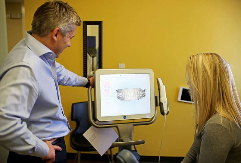 Doctor reviewing the smile with patient on monitor.